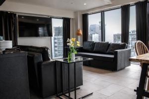 a living room with a couch and a table at 大阪難波リバーサイドガーデンホテルOsaka Namba River Side Garden Hotel in Osaka