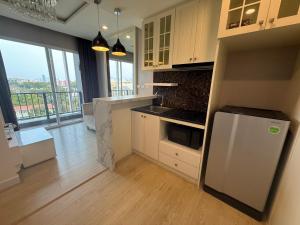 a kitchen with a refrigerator and a counter top at The Patio See Sea 155 in Ban Bang Saen (1)