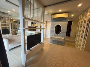 a living room with a flat screen tv and a couch at The Patio See Sea 155 in Ban Bang Saen (1)