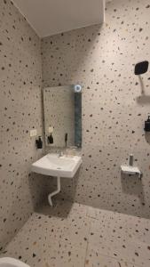 a bathroom with a sink and a mirror at BLEU by NIRVANA in Mahabalipuram