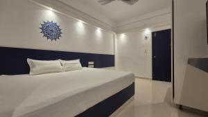 a bedroom with a bed with a blue snowflake on the wall at BLEU by NIRVANA in Mahabalipuram +2 photos