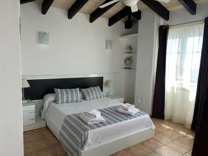 a bedroom with a bed with towels on it at Chalet en Calan Forcat in Cala en Forcat +32 photos