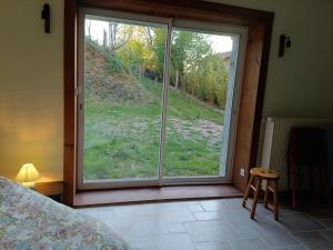 a bedroom with a window with a view of the grass at LeBoisDieu in Thizy-les-Bourgs