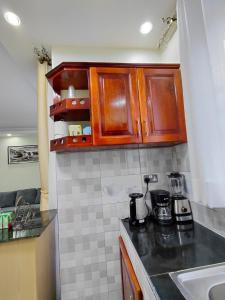 a kitchen with wooden cabinets and a counter top at Keirwa in Kampala +14 photos