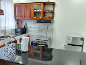 a kitchen with wooden cabinets and a counter top at Keirwa in Kampala