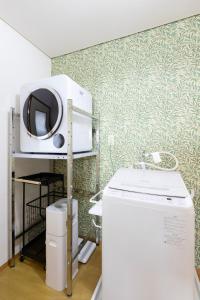 a microwave sitting on a shelf next to a refrigerator at gently stay Nagoya in Nagoya