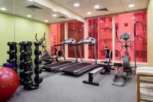 a gym with treadmills and ellipticals in a room at Ibis Hong Kong Central & Sheung Wan in Hong Kong