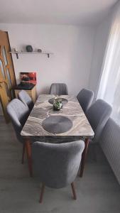 a dining room with a table and four chairs at Casa Vatra Dornei in Vatra Dornei