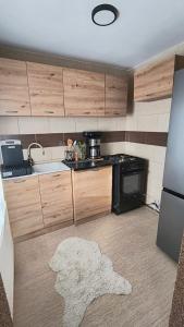 a kitchen with a sink and a stove at Casa Vatra Dornei in Vatra Dornei