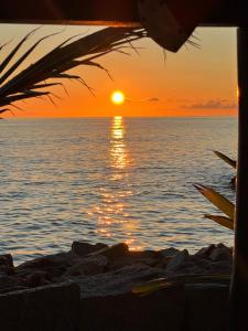 a sunset over the ocean with the sun setting at Sunset Cove Villa in Grand'Anse Praslin