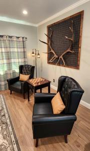 a living room with two chairs and a table with chess at The fancy Shanty in Pilot Hill