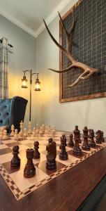 a wooden chess board with chess pieces on it at The fancy Shanty in Pilot Hill