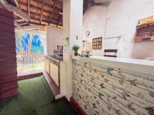 a kitchen with a wall with birds painted on it at RnB Beach Resort in Anjuna