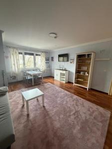 a living room with a coffee table and a table at Apartments Nicole in Baden