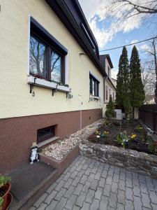 a teddy bear sitting outside of a house at Apartments Nicole in Baden