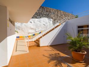 a staircase in a building with a stone wall at Incredible Sunsets in Puerto Rico de Gran Canaria