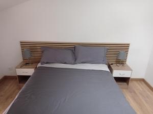 a bedroom with a bed with two night stands at chemin de compostelle in Montcuq