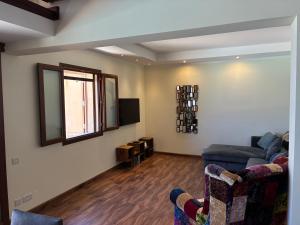 a living room with a couch and a window at Fort Chambray Island Views in Għajnsielem