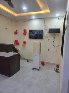 a room with a television and balloons on the wall at Hotel Galaxy in Mundarwa