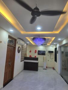 a room with a ceiling fan and a lobby at Hotel Galaxy in Mundarwa