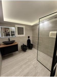 a bathroom with two toilets and a sink at Xhejn's Veranda 7 in Durrës +25 photos