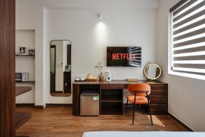 a room with a desk with a chair and a mirror at V Living - Downtown Saigon Stay with Free Laundry in Ho Chi Minh City +78 photos