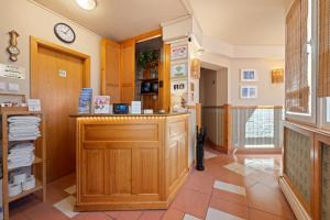 a room with a counter and a clock on the wall at Boulevard City Panzió - self check-in in Budapest