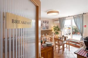 a kitchen and dining room with a table and chairs at Boulevard City Panzió - self check-in in Budapest +16 photos