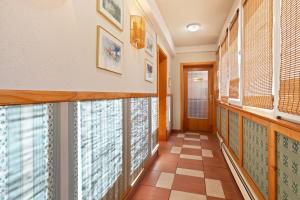 a hallway with windows and a tile floor at Boulevard City Panzió - self check-in in Budapest