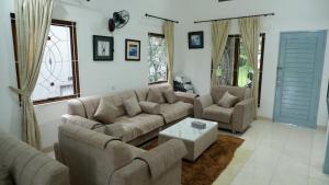 a living room with two couches and a table at villa NC3 31 Kota Bunga in Cikundul