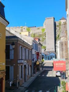 an empty street in a town with a castle at Appartement Centre in Lourdes