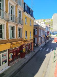an empty street in a city with buildings at Appartement Centre in Lourdes