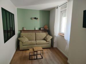 a living room with a couch and a table at Appartement Centre in Lourdes