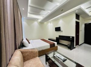 a hotel room with a bed and a desk at Sea Paradise in Cox's Bazar