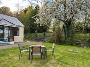 a table and chairs sitting in a yard at The Wild Atlantic Hideaway in Inch