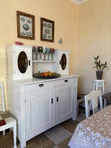 a white cabinet with a plate of fruit on it at Pitch Provence B&B in Ollioules