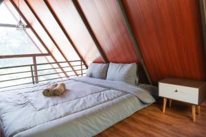 a bed in a room with a large window at Glamping Triangle Kusumanagara 1 in Bandung +1 photo