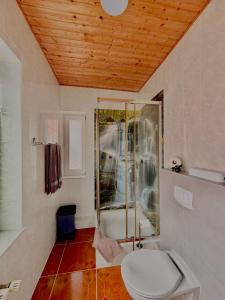 a bathroom with a toilet and a glass shower at Pension Dang in Norddeich +58 photos