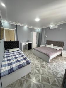 a large bedroom with two beds and a bathroom at Marina kvariati in Kvariati