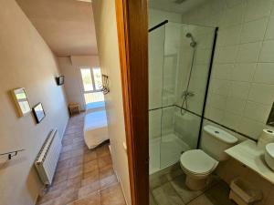 a bathroom with a shower and a toilet and a sink at Hostal JP y Estudios in Sangüesa +43 photos