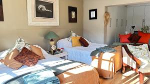 a bedroom with two beds with pillows on them at Artzy's Garden View 1km to Olivedale Clinic in Northriding