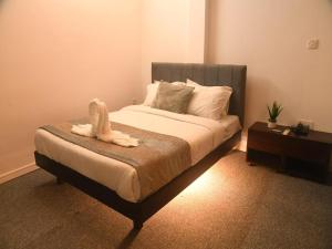 a bedroom with a bed with an animal on it at Al Aziz Hotel Sylhet in Sylhet