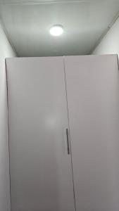 a white cabinet in a room with a ceiling at Malbon Green Executive Plus Lodge in Kafue