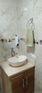 a bathroom with a white sink on a counter at Habitación in Itagüí