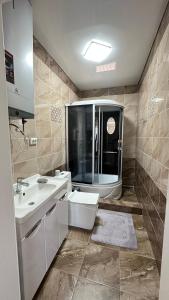 a bathroom with a sink and a toilet and a shower at Гостевой дом in Tokmok