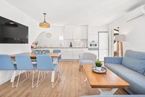 a living room and kitchen with a table and chairs at Apartment BINIBECA 60 in Binibeca
