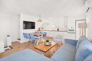 a living room with a blue couch and a table at Apartment BINIBECA 60 in Binibeca