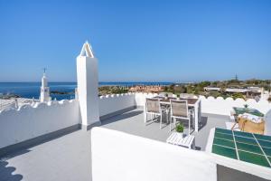 a balcony with a table and chairs and the ocean at Apartment BINIBECA 60 in Binibeca