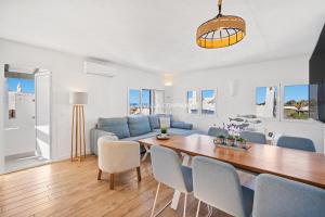 a living room with a table and a blue couch at Apartment BINIBECA 60 in Binibeca +11 photos