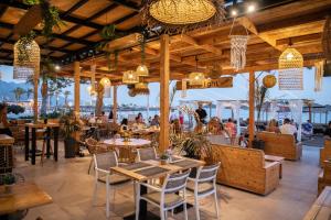 a restaurant with tables and chairs and a view of the water at Starlight Ocean View in Kardamaina